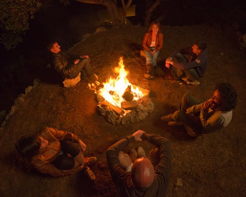 Campfire of friends in circle on the fire